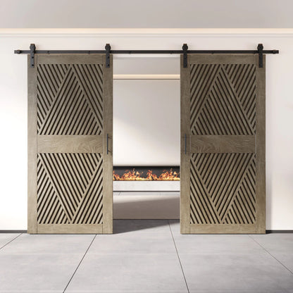 Two fully closed double barn doors in a classic gray finish, featuring a bold, intricate diamond slat pattern. The doors are installed with black sliding hardware against a white wall, revealing a modern linear fireplace in the space behind them.