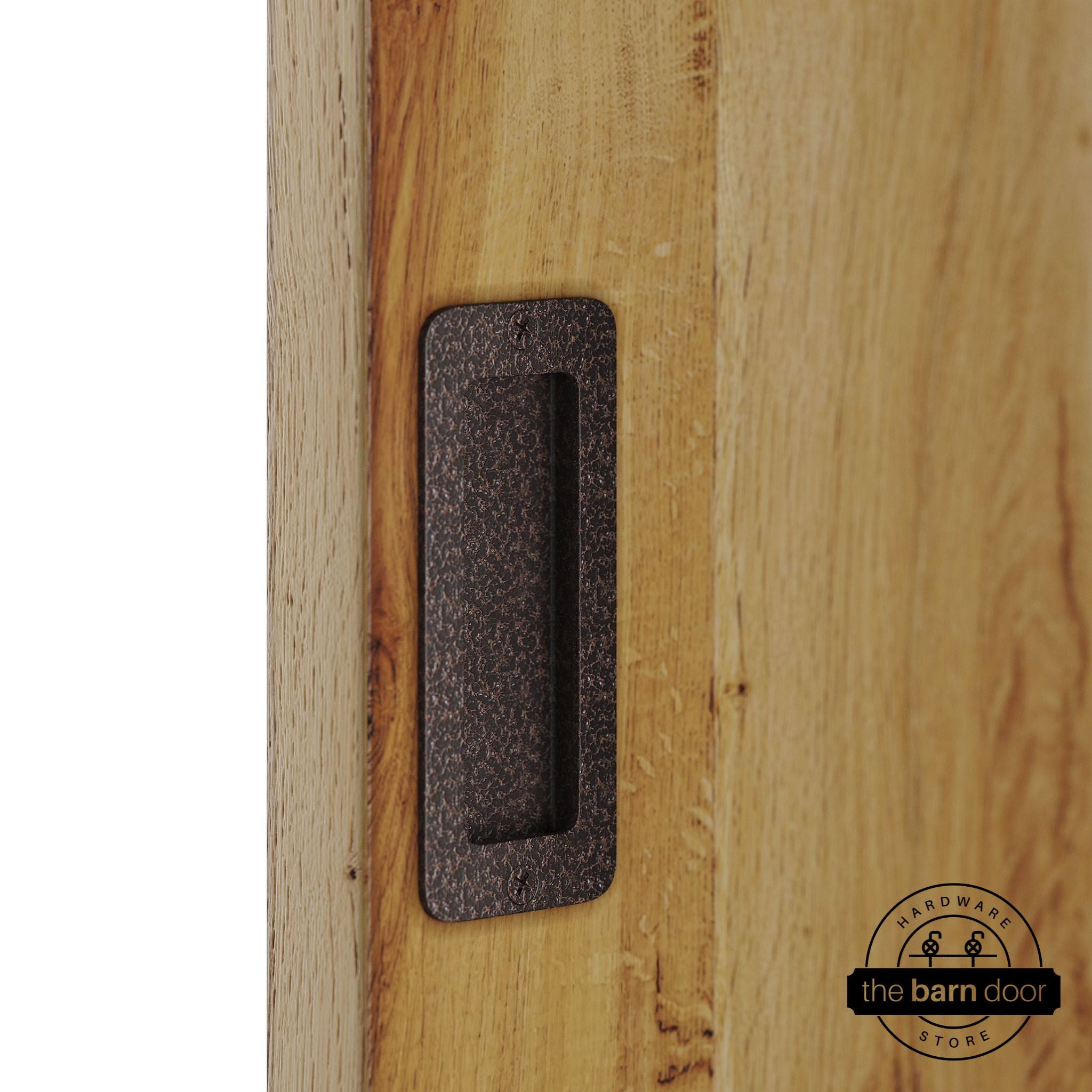 Copper vein partial radius flush pull handle for sliding barn doors, installed on natural wood door panel