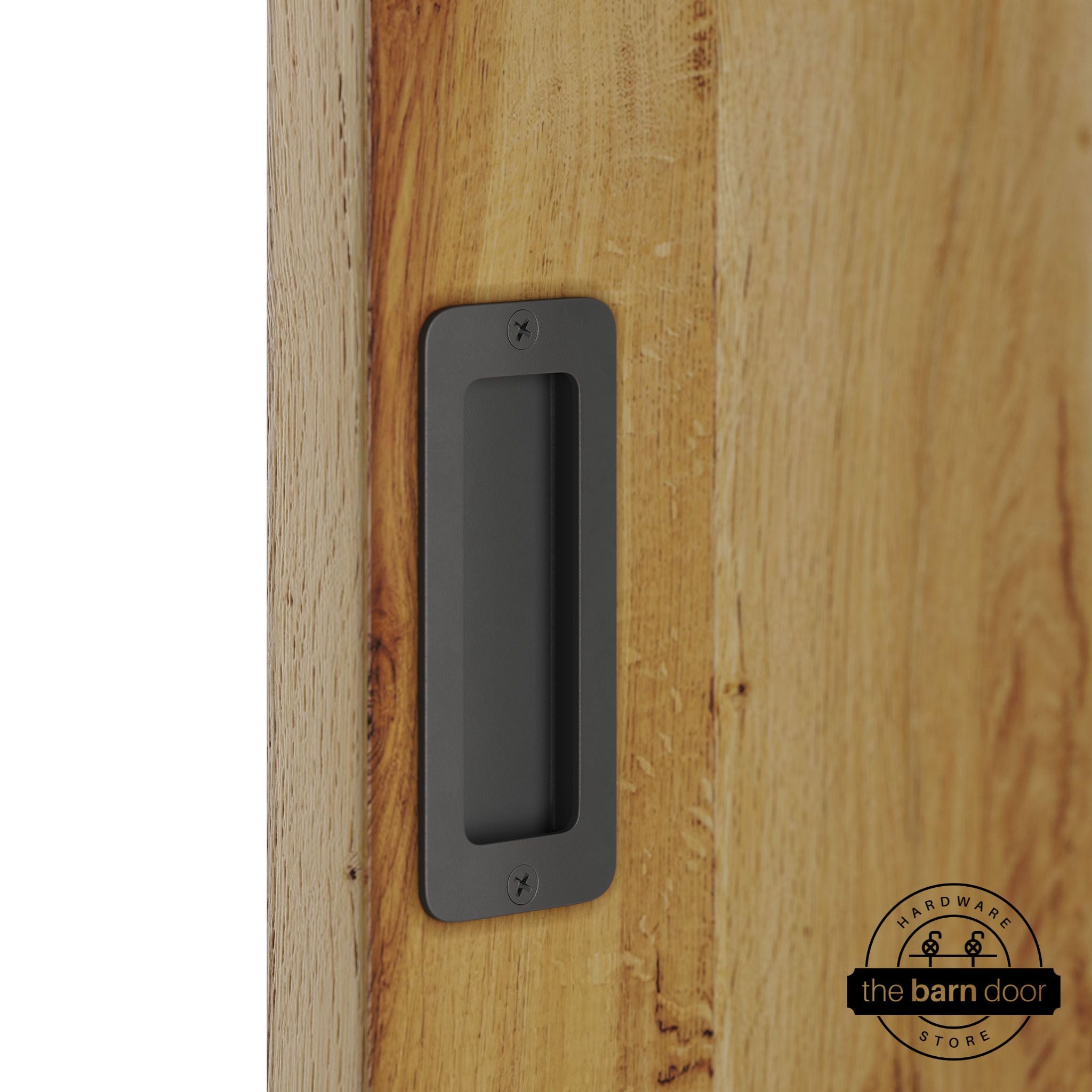 Dark gray partial radius flush pull handle for sliding barn doors, installed on natural wood door panel