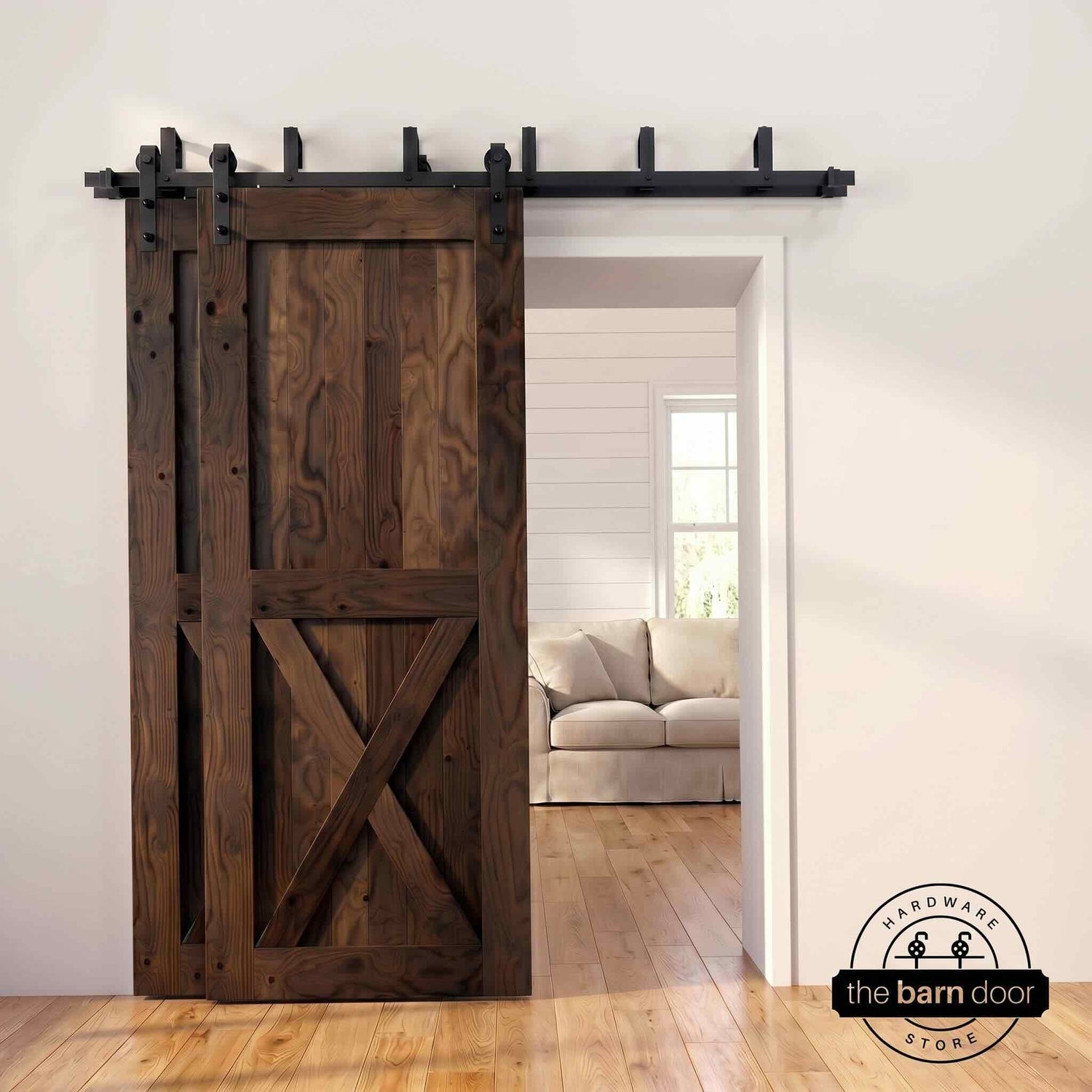 Dark walnut pine bypass barn door with  black hardware track, mounted over living room entryway