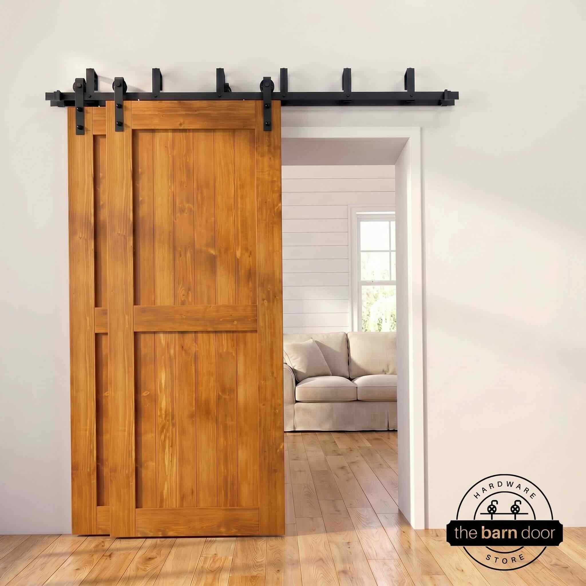 Early american pine bypass barn door with  black hardware track, mounted over living room entryway