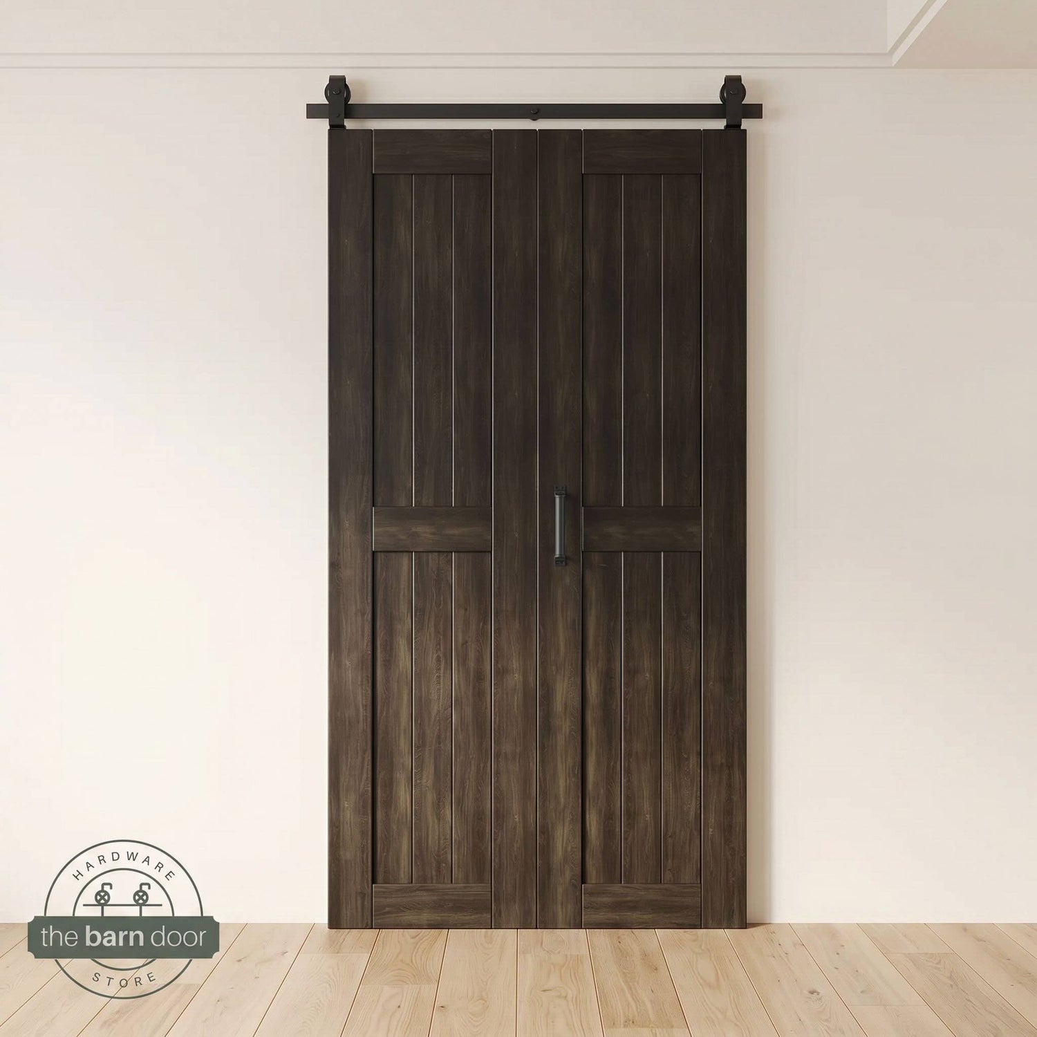 Two-panel bifold barn door in an ebony finish, installed and fully closed in a modern interior, showing the top-mount Matte Black track.