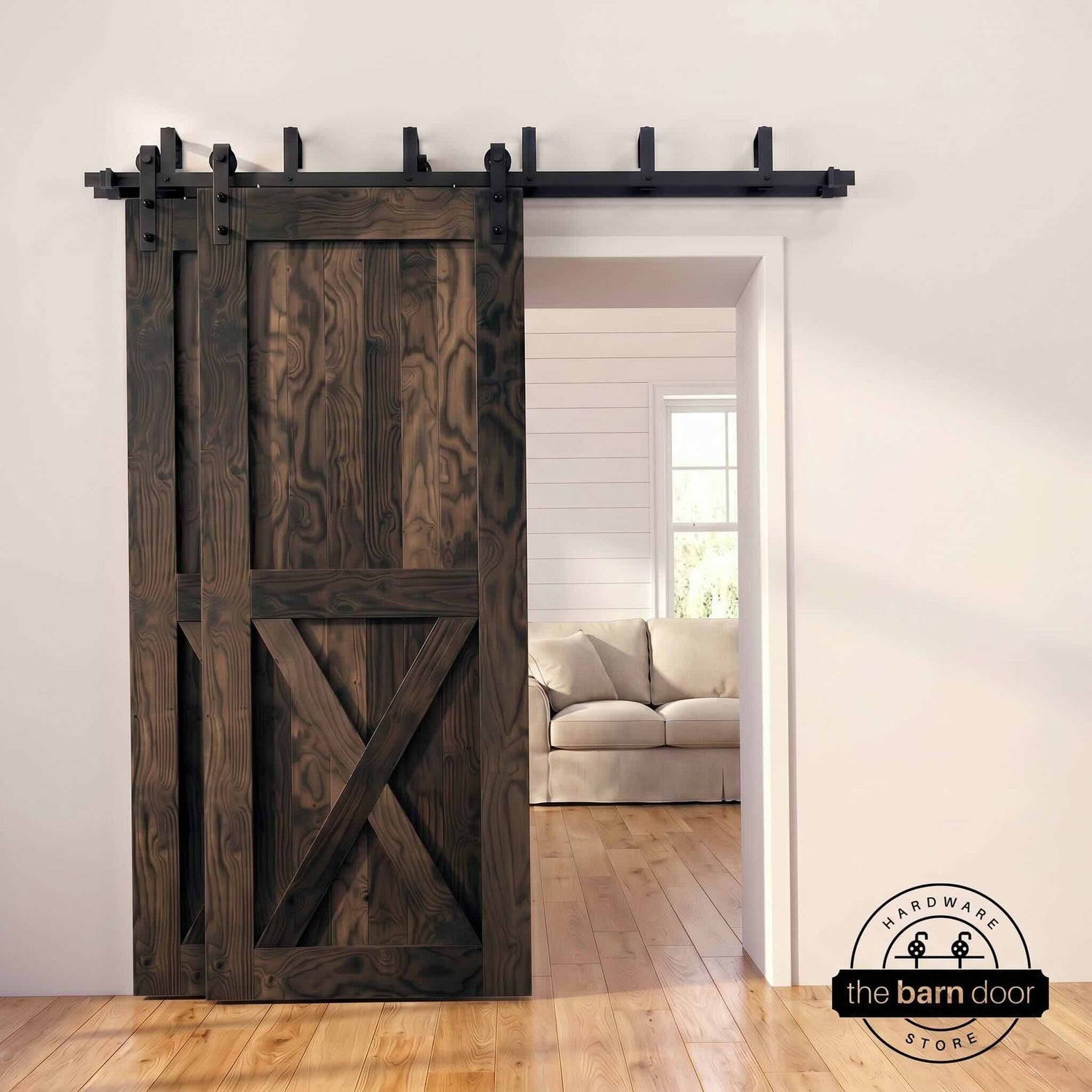 Ebony pine bypass barn door with  black hardware track, mounted over living room entryway