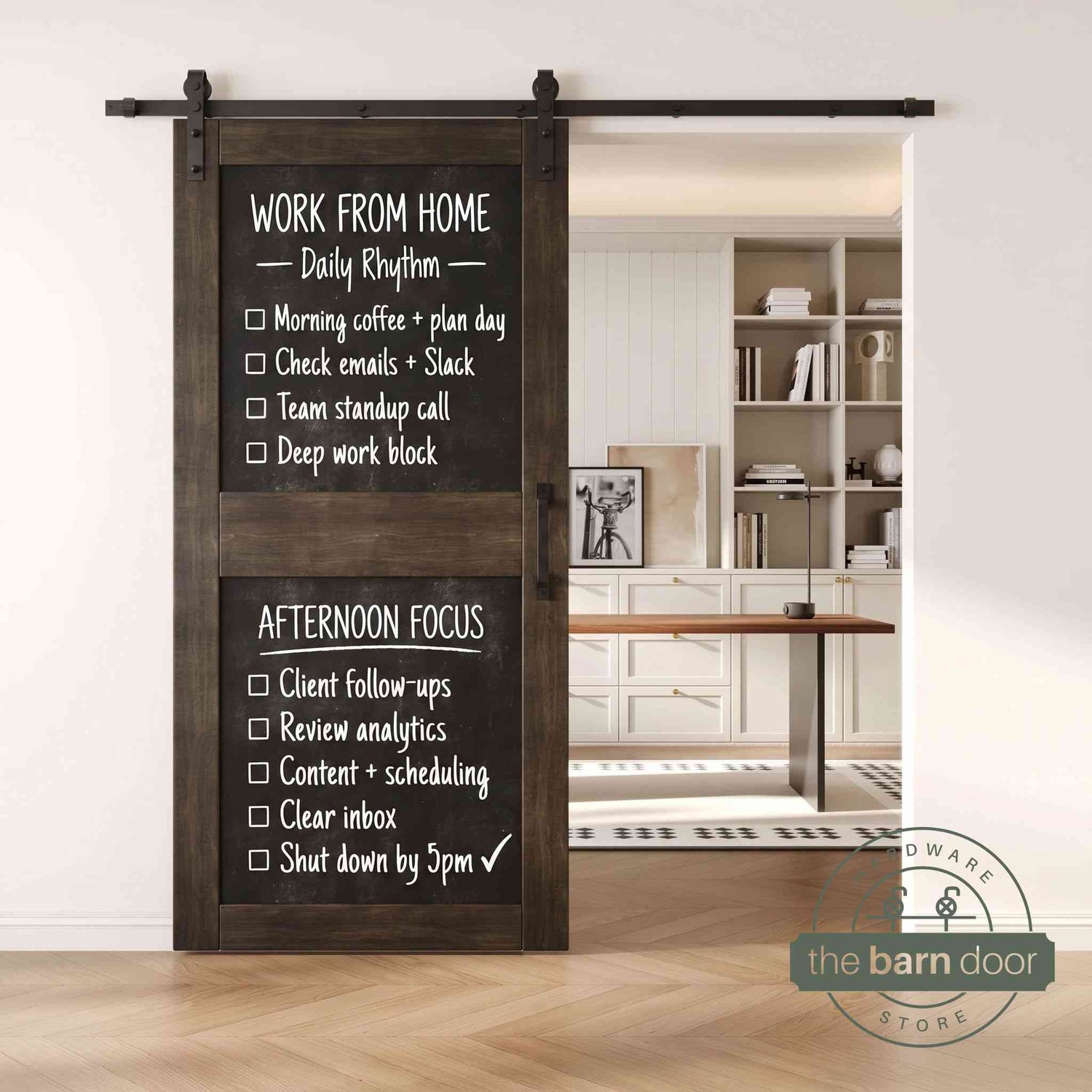 A ebony two-panel chalkboard barn door mounted on a sleek black sliding track, shown partially open to reveal a modern home office with built-in white shelving.