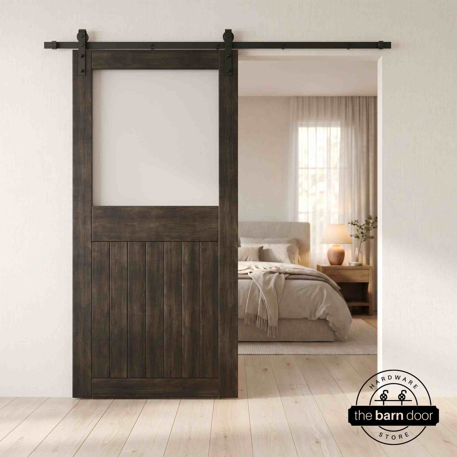 Ebony sliding half-lite frosted glass barn door in a modern interior setting with a desk and shelves.