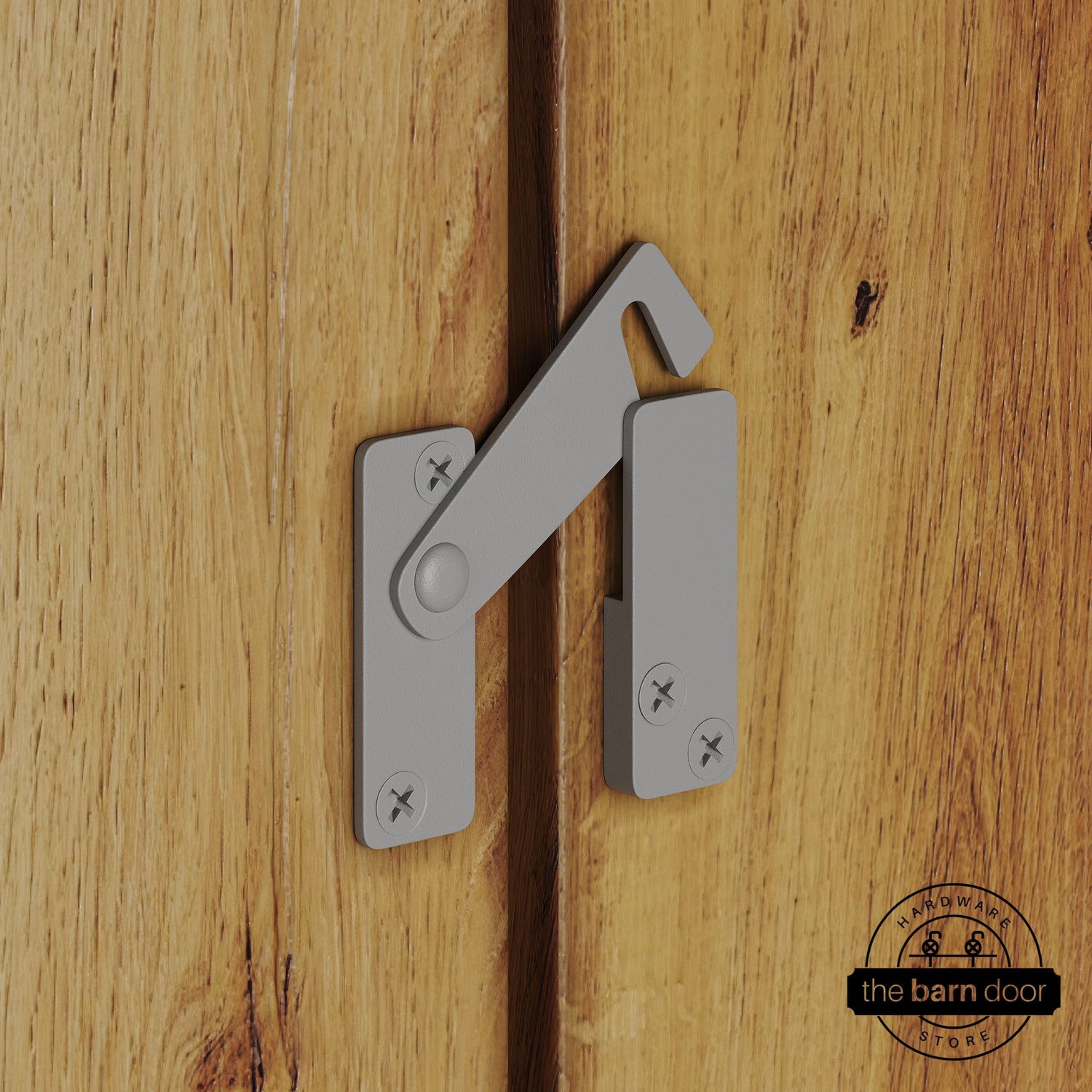 Flint gray privacy latch for biparting barn doors, shown latched across two wood door panels