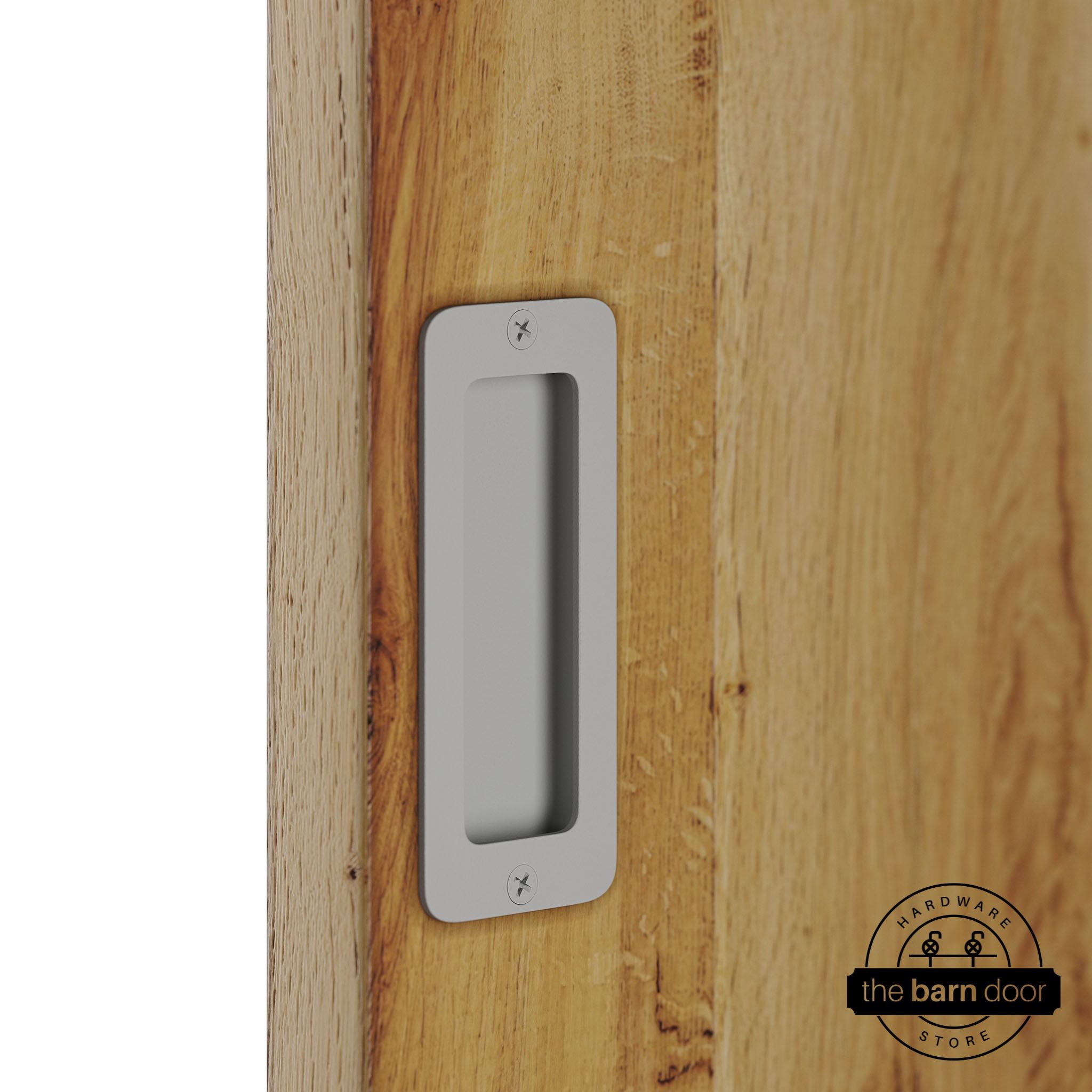 Flint gray partial radius flush pull handle for sliding barn doors, installed on natural wood door panel