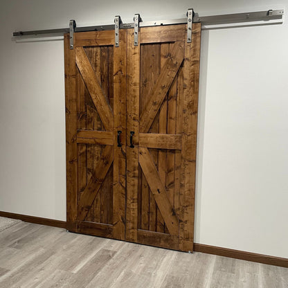Wooden sliding barn doors with J-strap brushed nickel hardware on a white wall