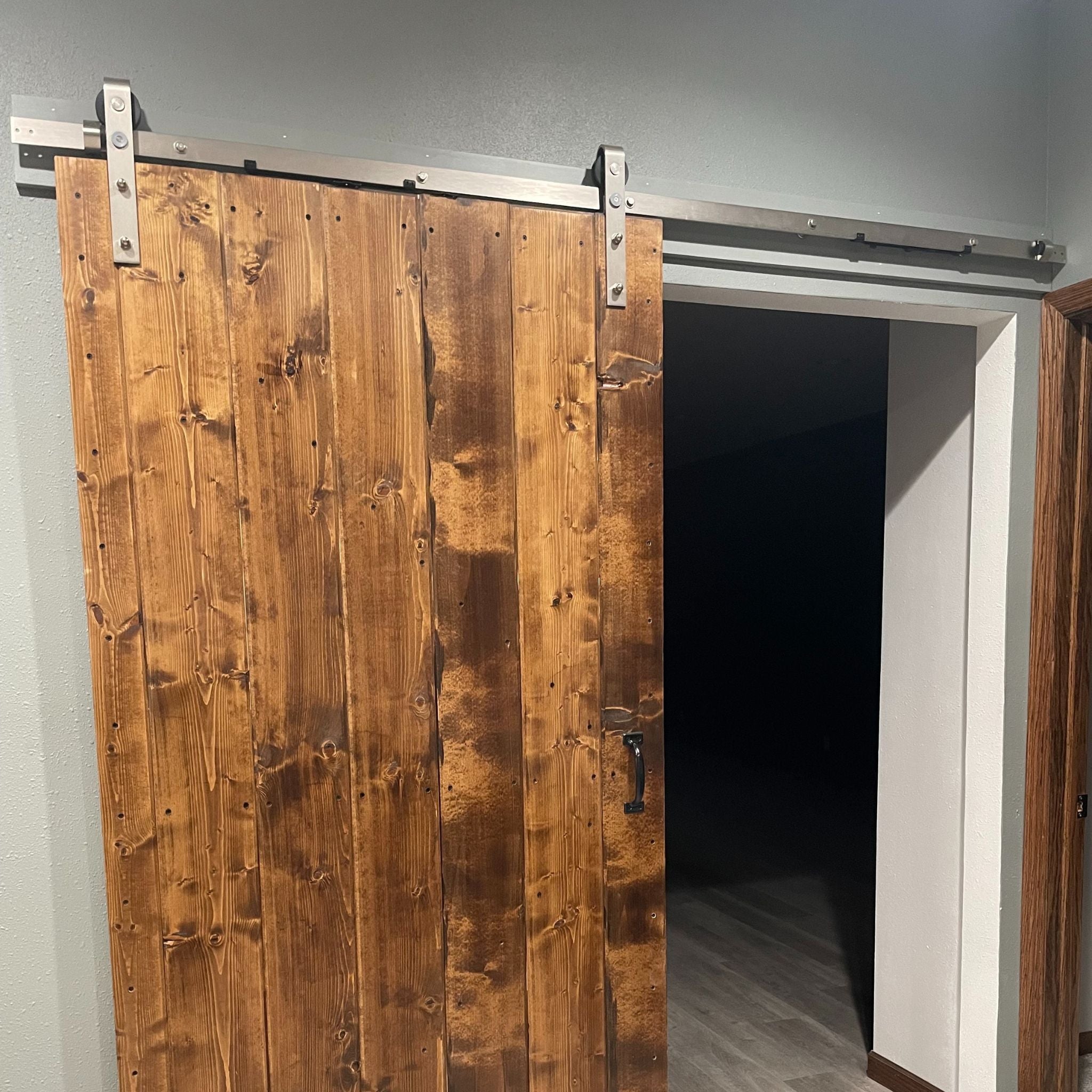 Wooden sliding barn door in a modern interior setting