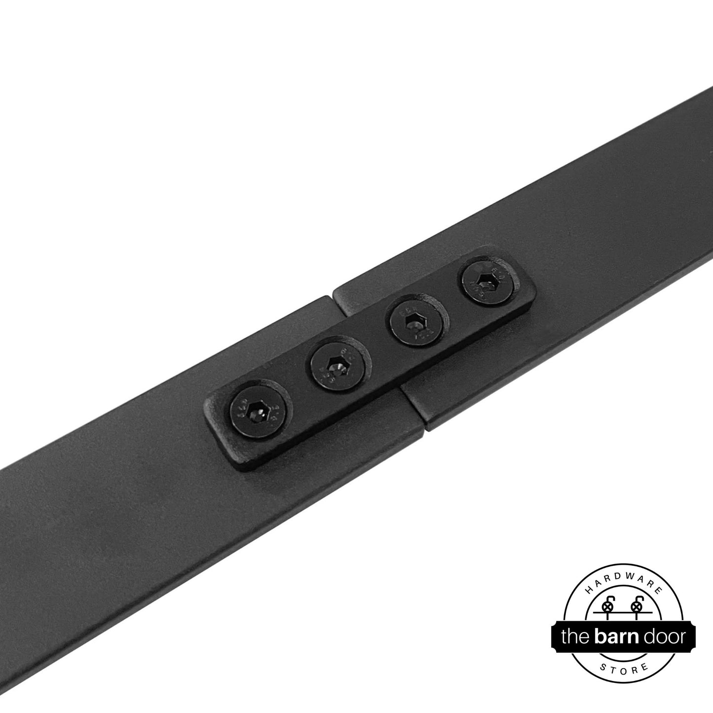 Detailed view of a black junction plate securing two sections of barn door track, with the plate sitting on top of the track pieces.