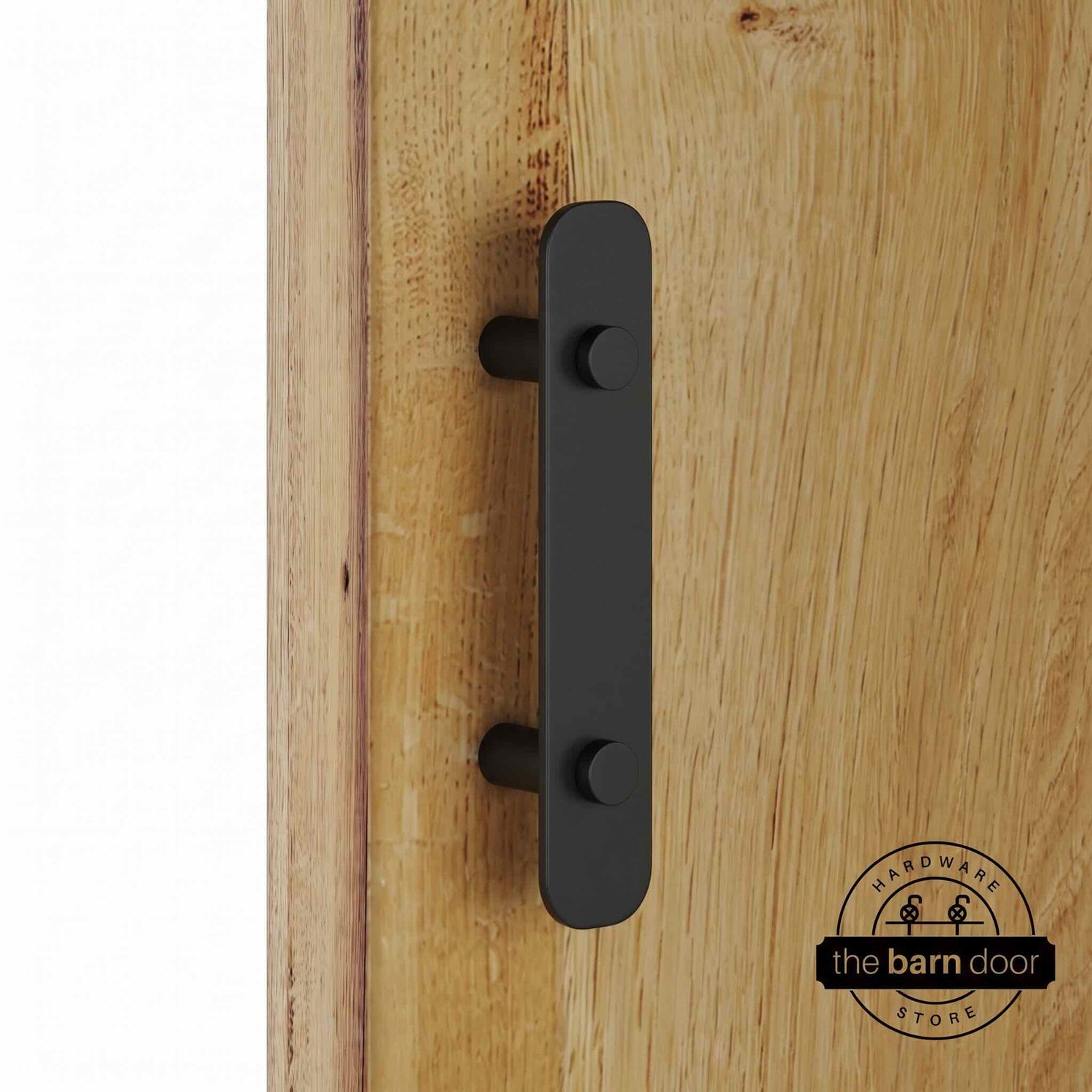 Matte black powder-coated stainless steel barn door flat bar pull handle on standoffs, mounted on a natural wood sliding barn door