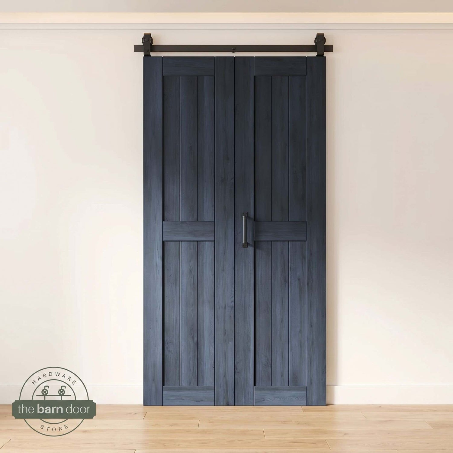 Two-panel bifold barn door in a navy blue finish, installed and fully closed in a modern interior, showing the top-mount Matte Black track.