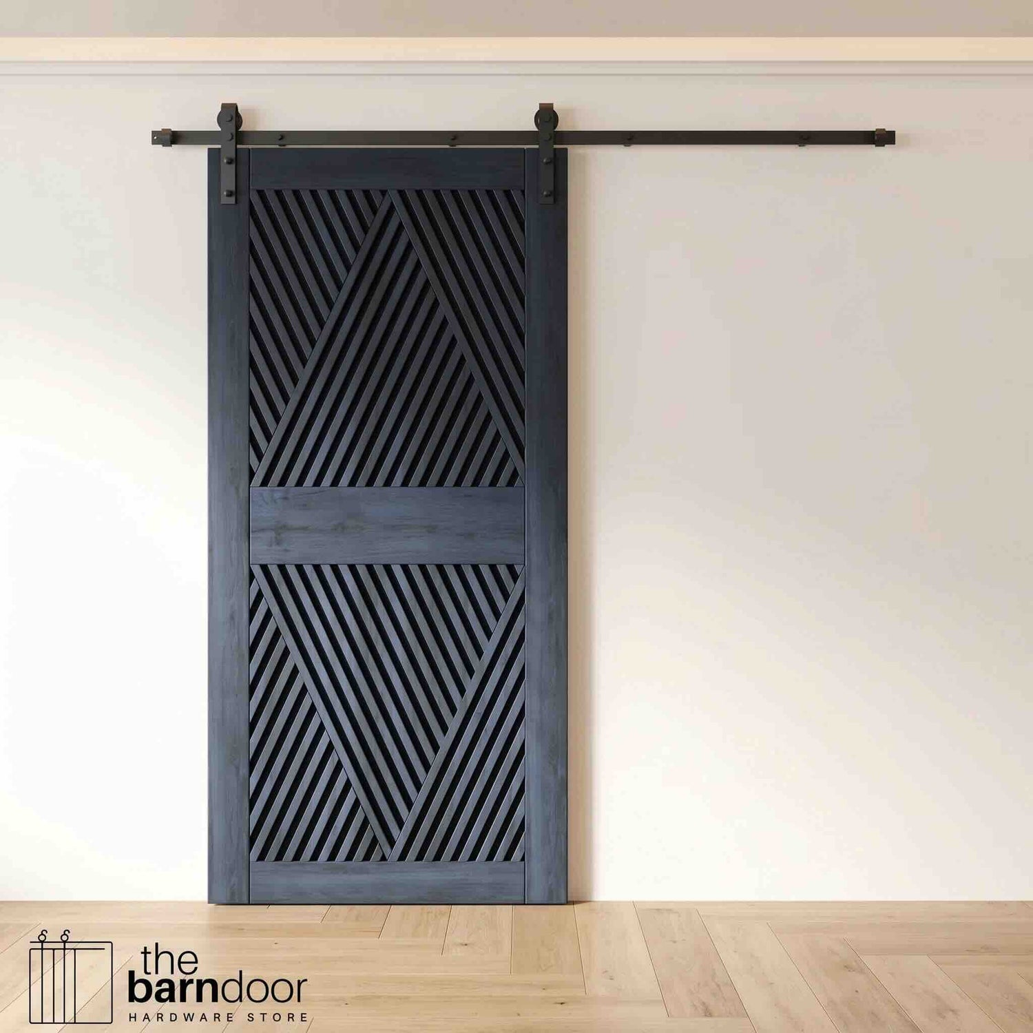 A modern navy barn door with an intricate geometric diamond pattern installed on a black track in a contemporary living space with a fireplace.