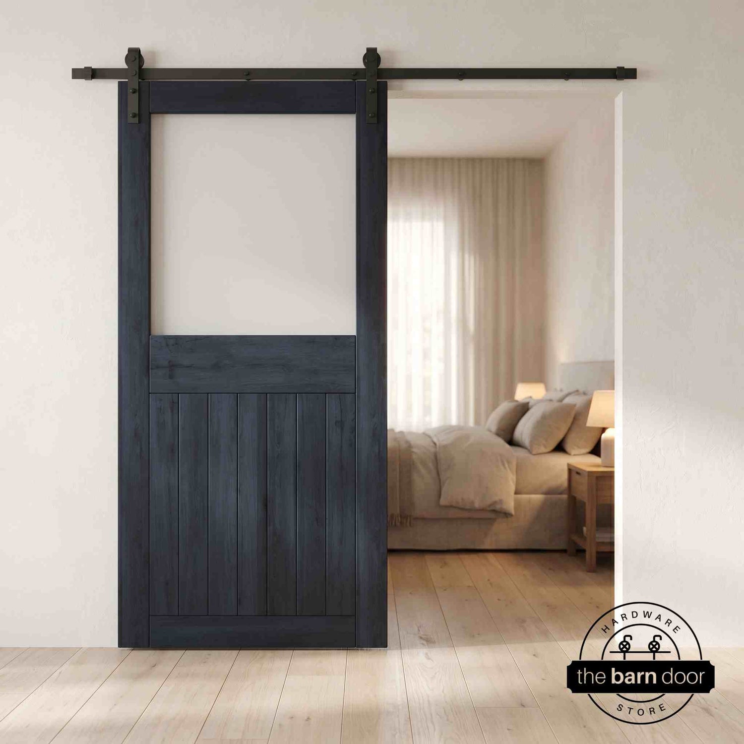 Navy sliding half-lite frosted glass barn door in a modern interior setting with a desk and shelves.