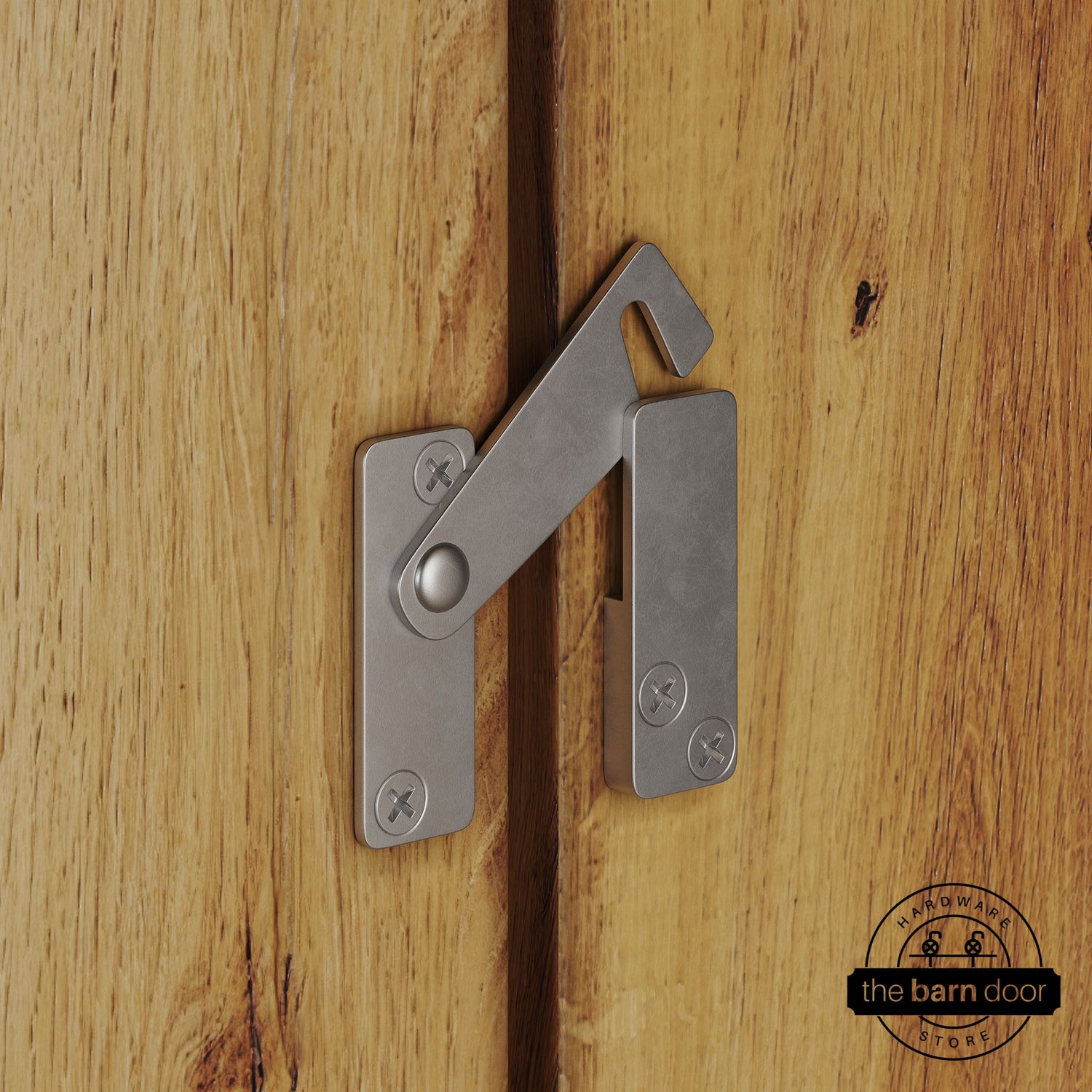 Raw steel privacy latch for biparting barn doors, shown latched across two wood door panels