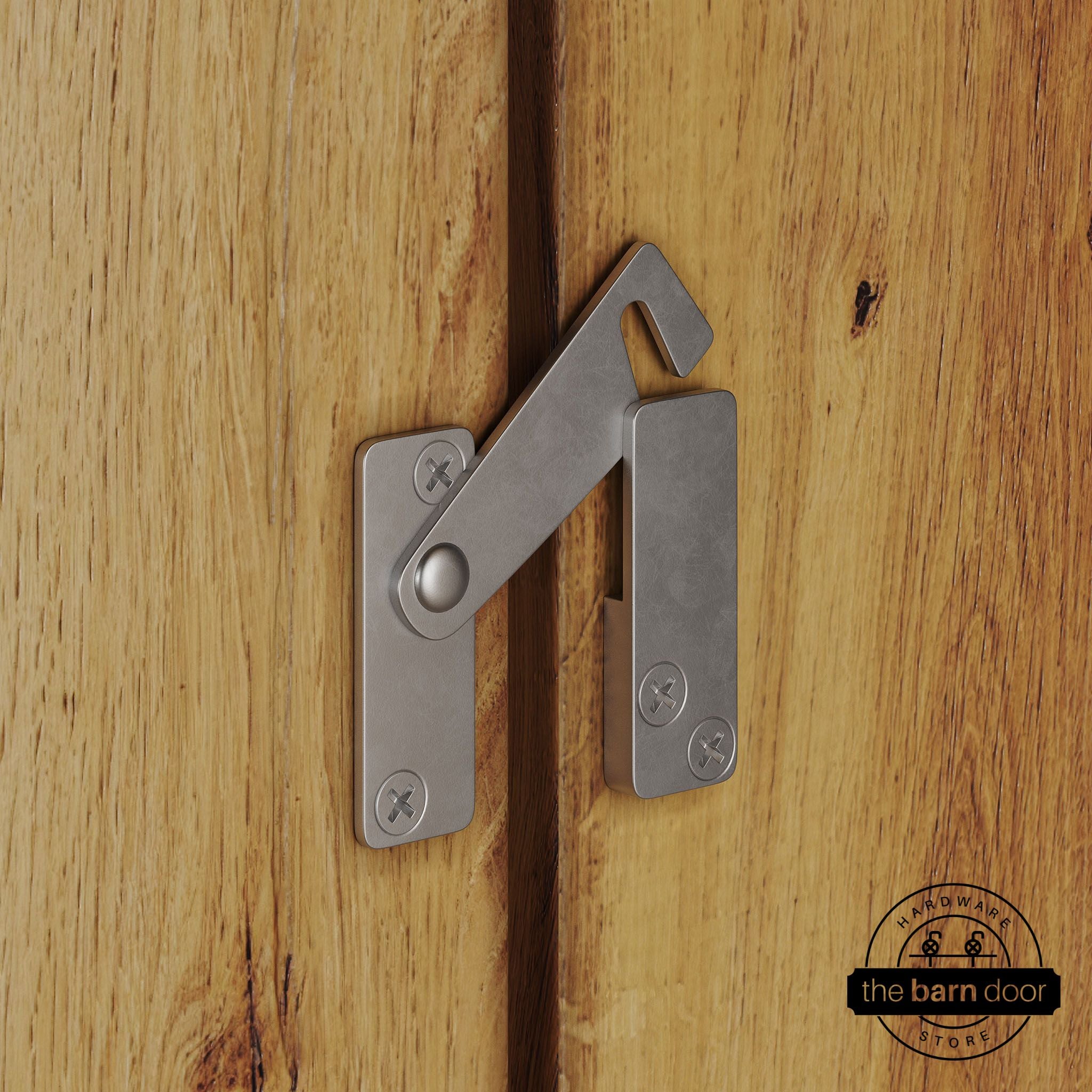 Raw steel privacy latch for biparting barn doors, shown latched across two wood door panels