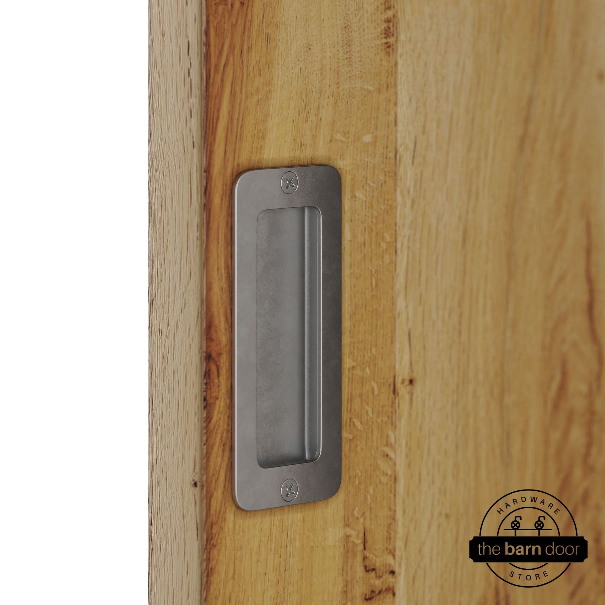 Raw steel partial radius flush pull handle for sliding barn doors, installed on natural wood door panel