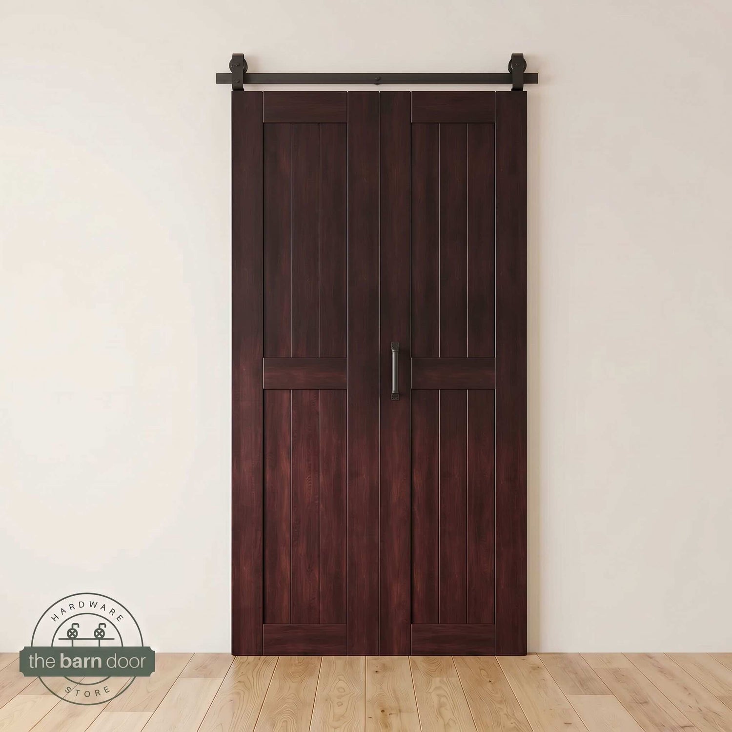 Two-panel bifold barn door in a red mahogany finish, installed and fully closed in a modern interior, showing the top-mount Matte Black track.