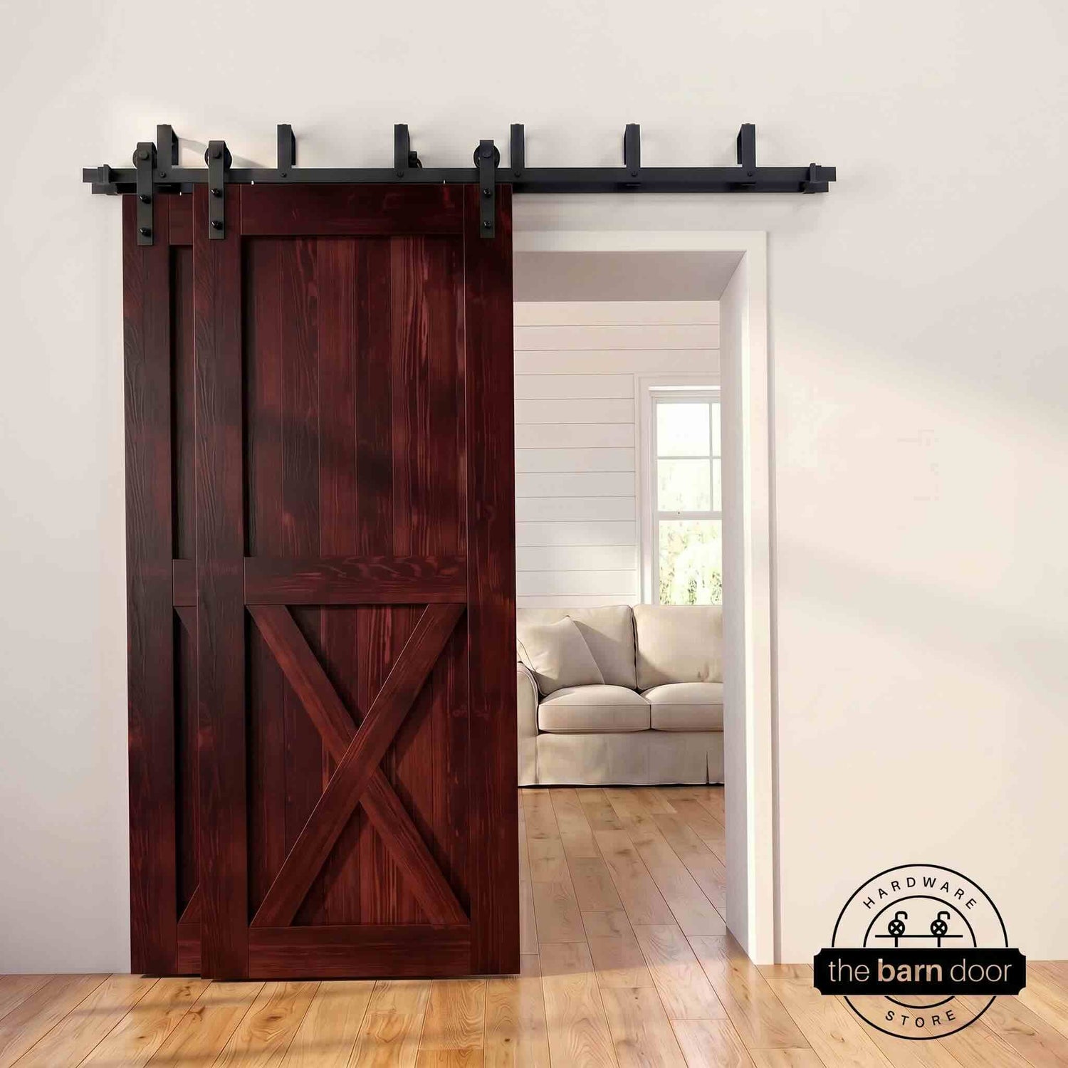 Red mahogany pine bypass barn door with  black hardware track, mounted over living room entryway