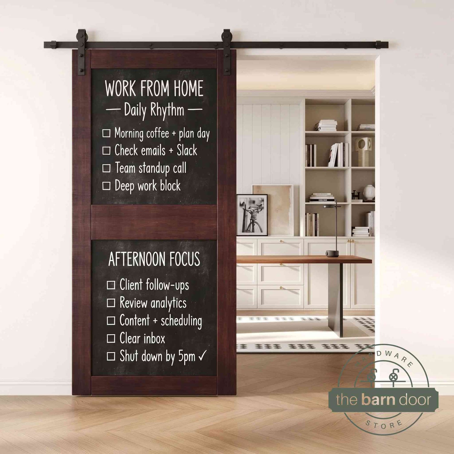 A red mahogany two-panel chalkboard barn door mounted on a sleek black sliding track, shown partially open to reveal a modern home office with built-in white shelving.