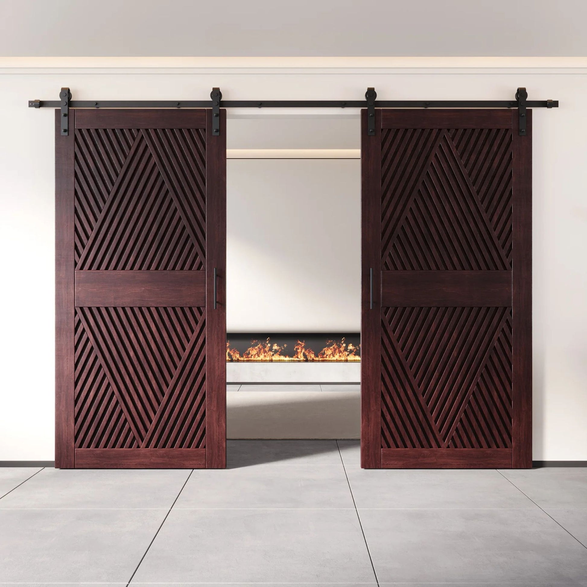Two fully closed double barn doors in a red mahogany finish, featuring a bold, intricate diamond slat pattern. The doors are installed with black sliding hardware against a white wall, revealing a modern linear fireplace in the space behind them.