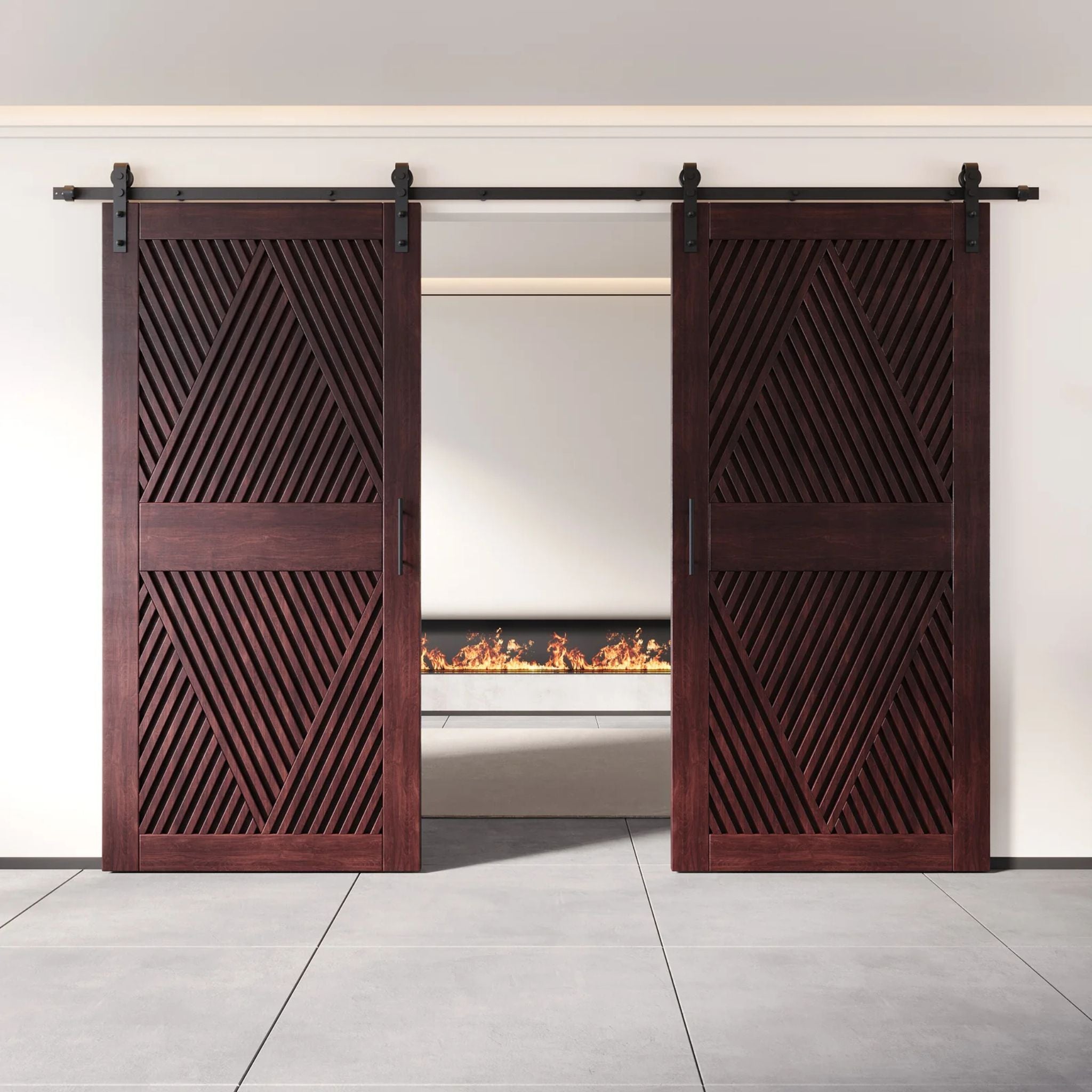 Two fully closed double barn doors in a red mahogany finish, featuring a bold, intricate diamond slat pattern. The doors are installed with black sliding hardware against a white wall, revealing a modern linear fireplace in the space behind them.