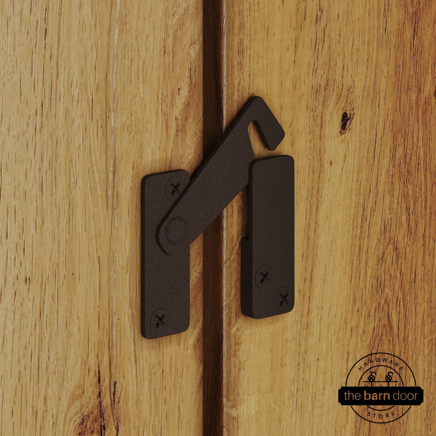 Rustic brown privacy latch for biparting barn doors, shown latched across two wood door panels