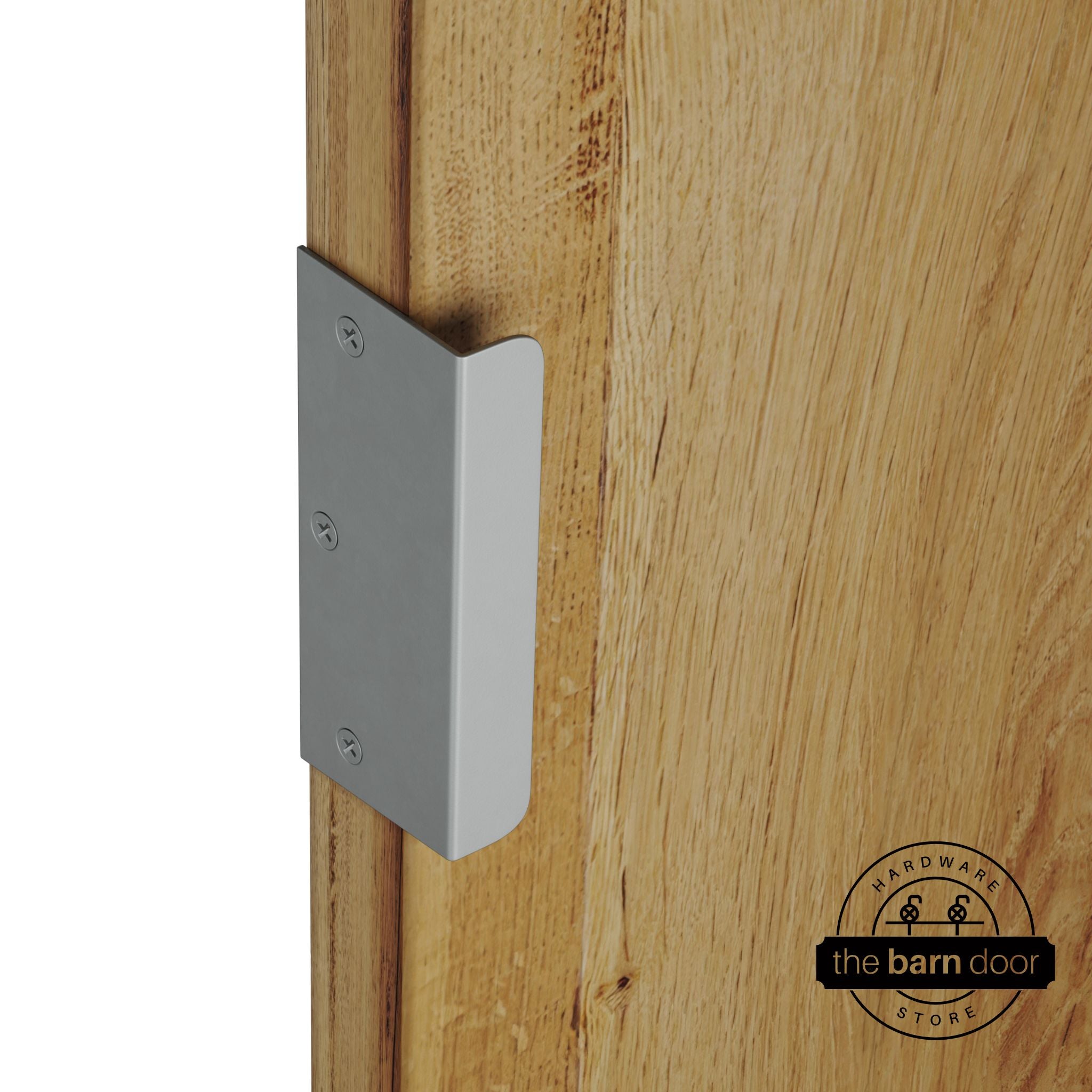 Silver metallic sliding barn door edge pull handle on natural wood door edge