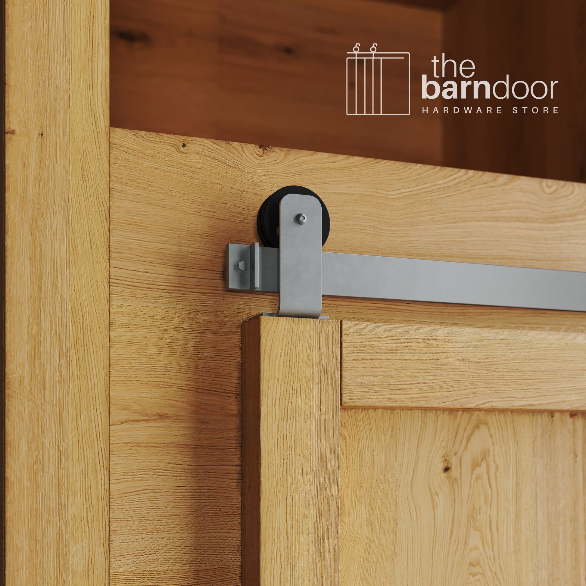 A close-up photograph of a sliding mini barn door on a natural oak cabinet, featuring silver metallic top-mount straight hardware.