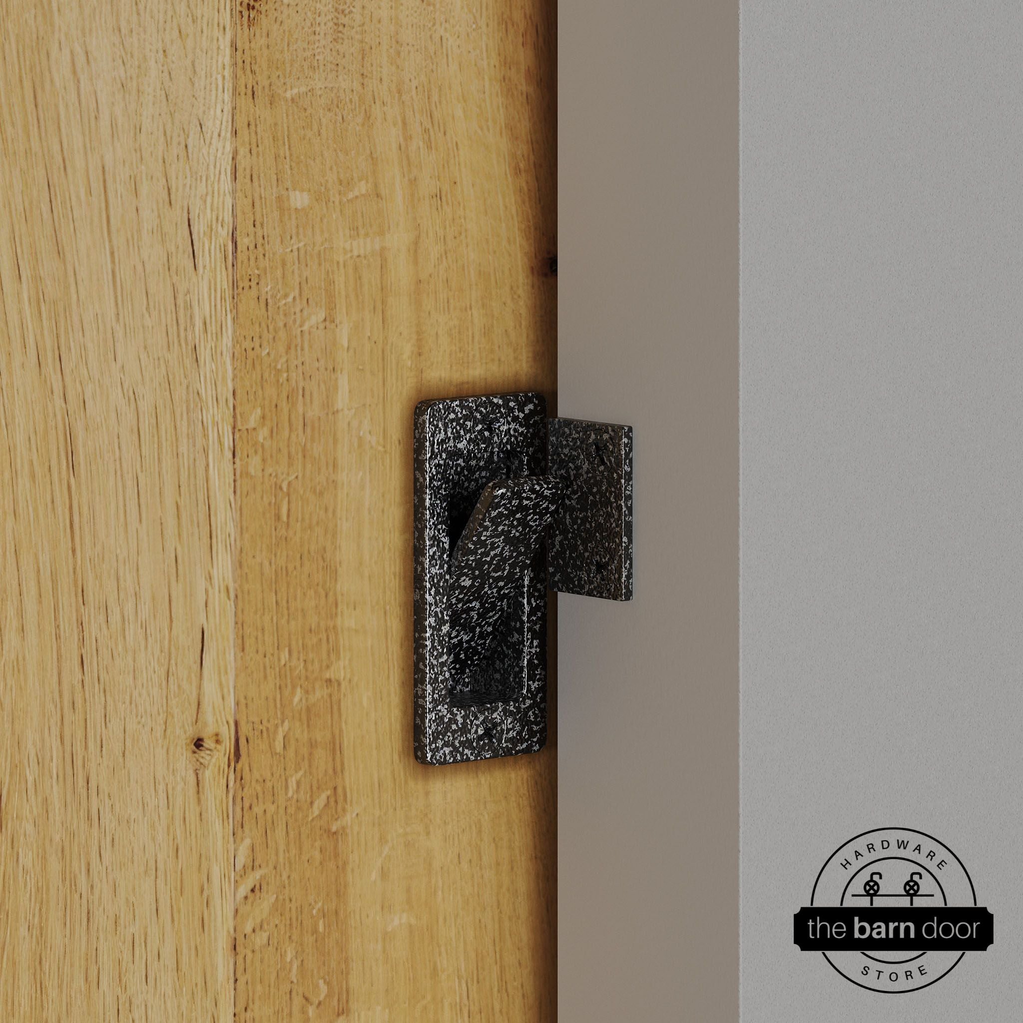 Silver vein privacy latch installed on a sliding barn door, shown in the locked position against door frame