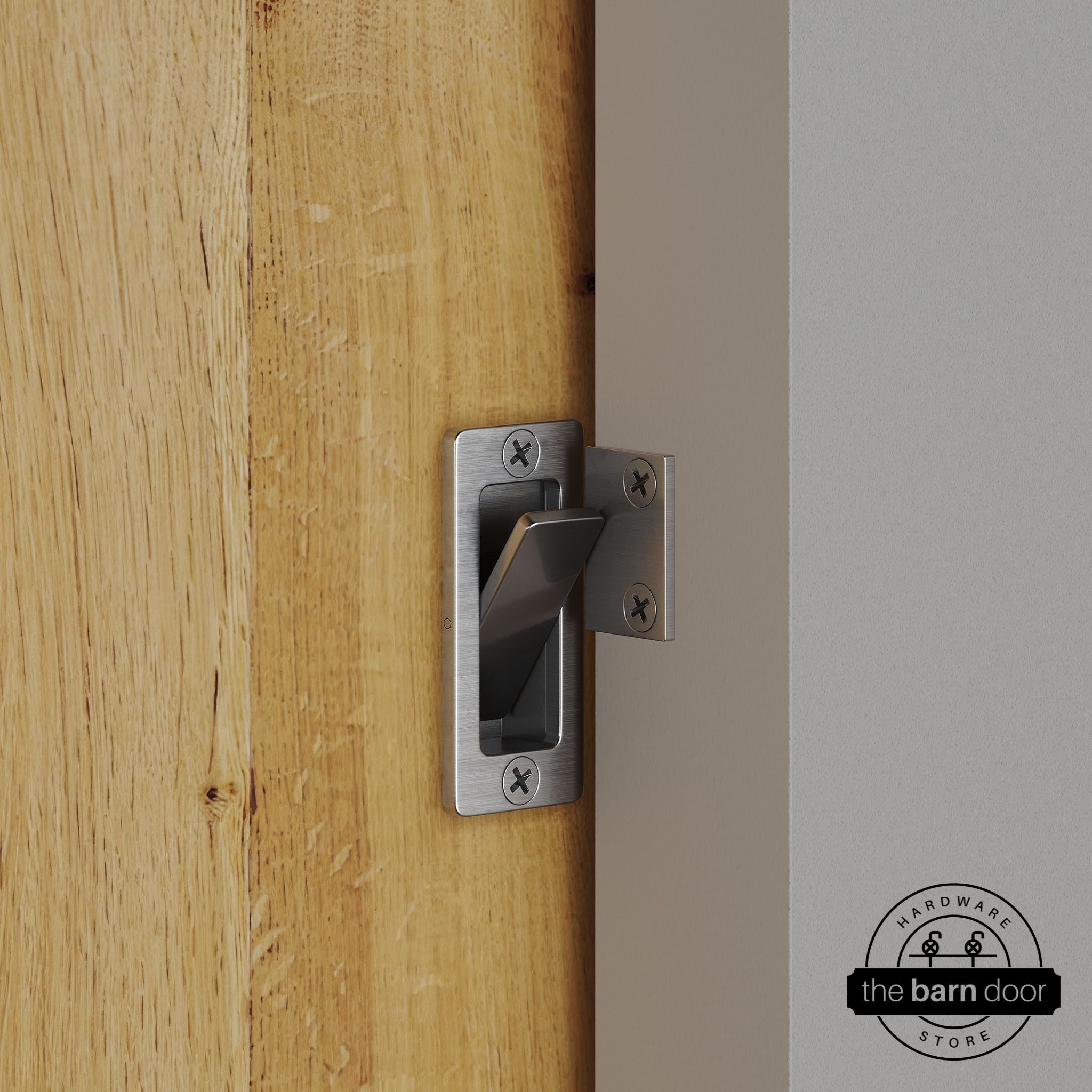 Stainless steel privacy latch installed on a sliding barn door, shown in the locked position against door frame