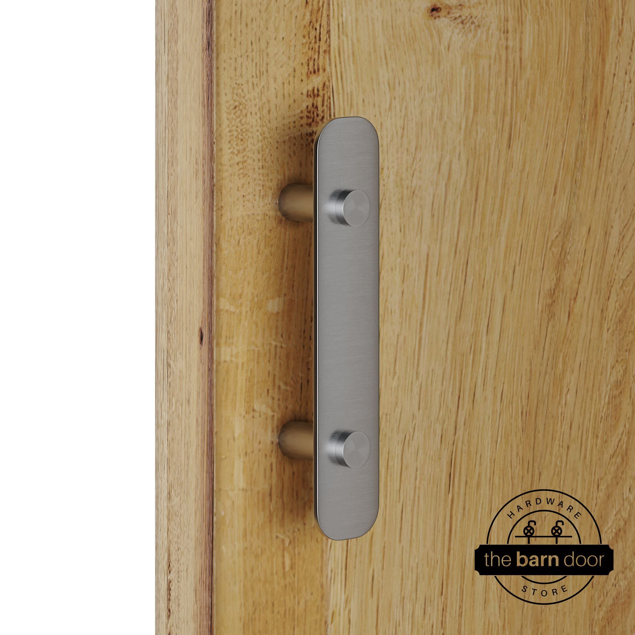 Stainless steel barn door pull handle with rounded backplate mounted on a natural wood sliding barn door