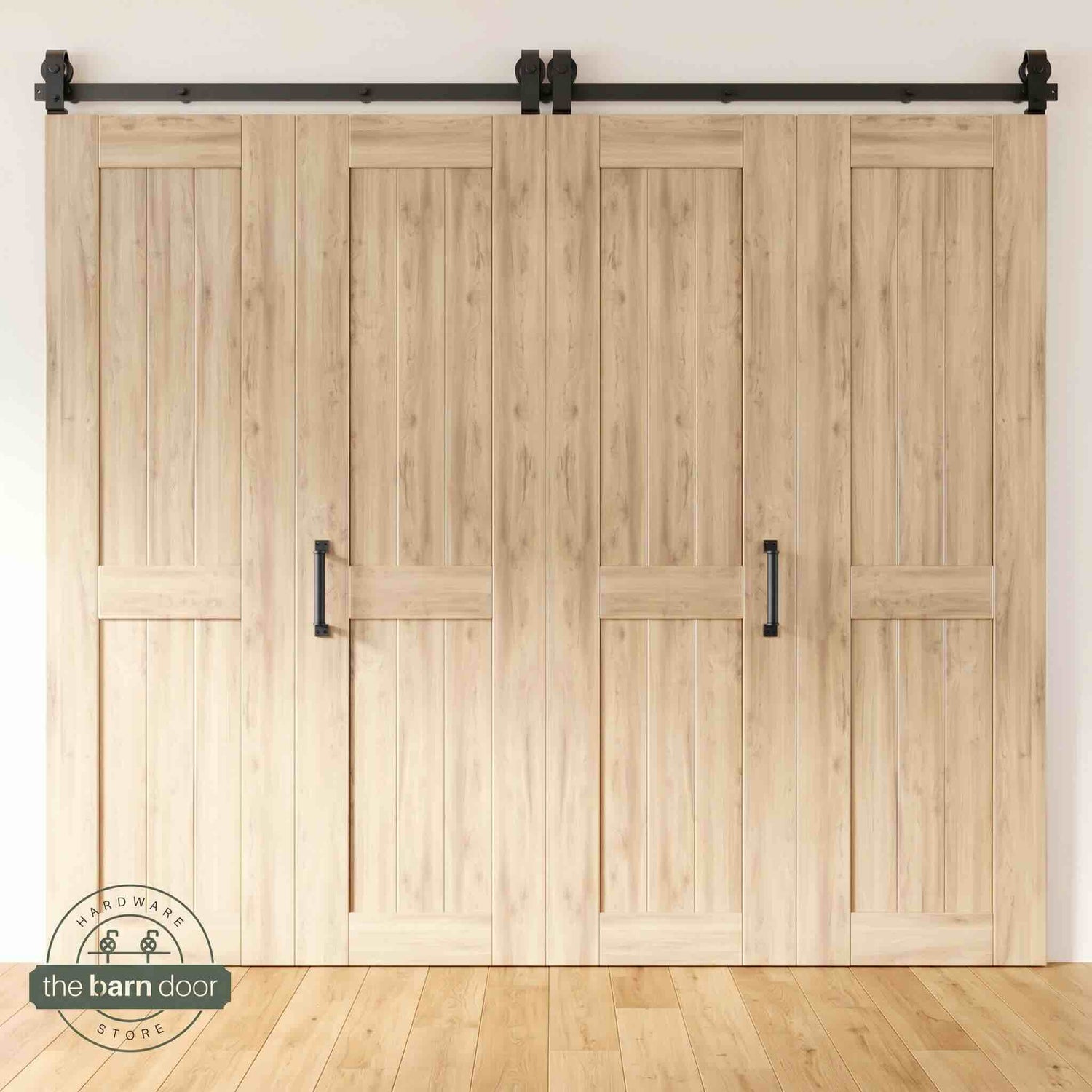 Four-panel bi-parting unfinished bifold barn door, fully closed in a modern entryway, showing the top-mount Matte Black track.