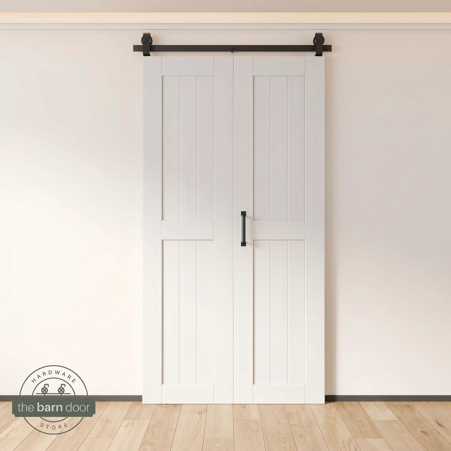 Two-panel bifold barn door in a white finish, installed and fully closed in a modern interior, showing the top-mount Matte Black track.