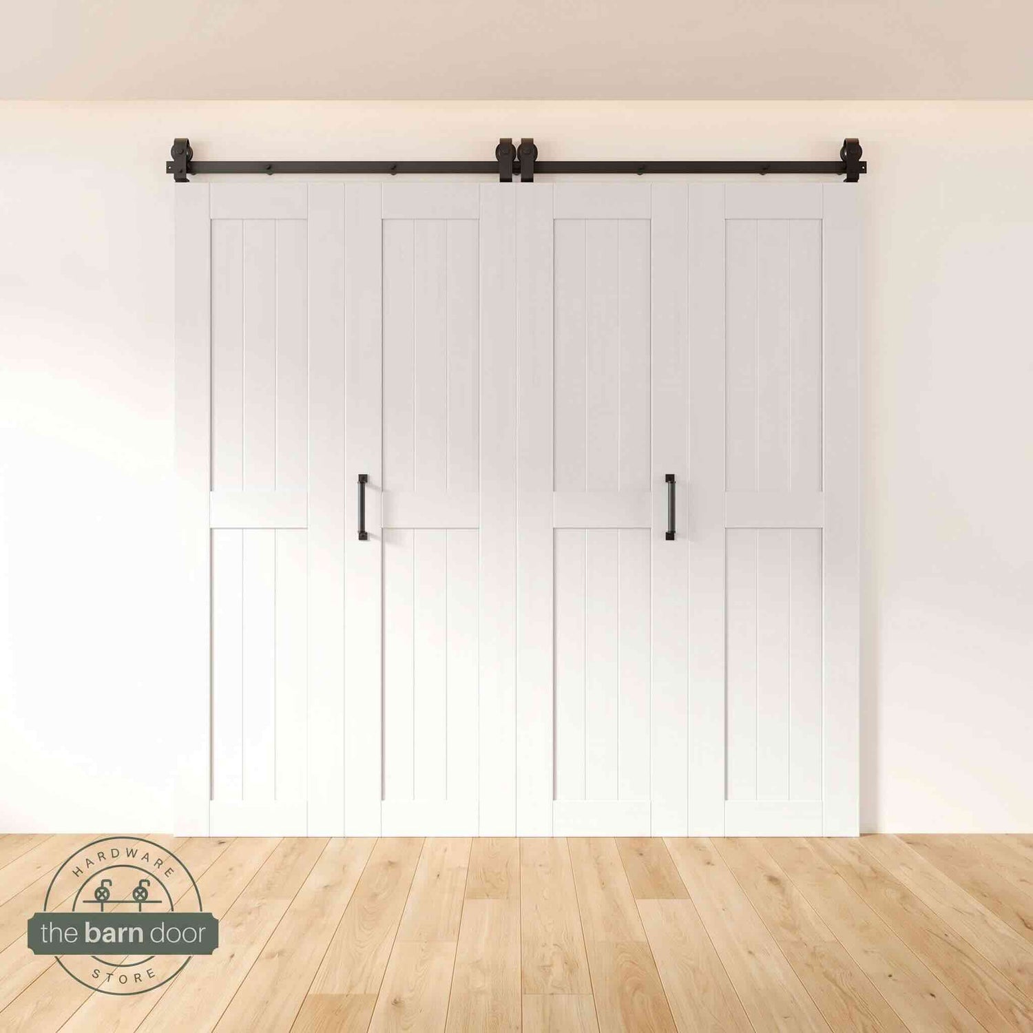 Four-panel bi-parting bifold barn door in a white finish, fully closed in a modern entryway, showing the top-mount Matte Black track.
