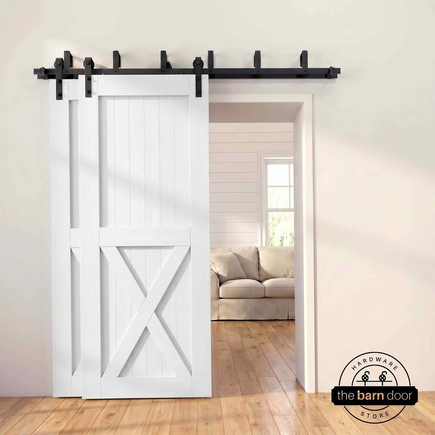 White pine bypass barn door with  black hardware track, mounted over living room entryway