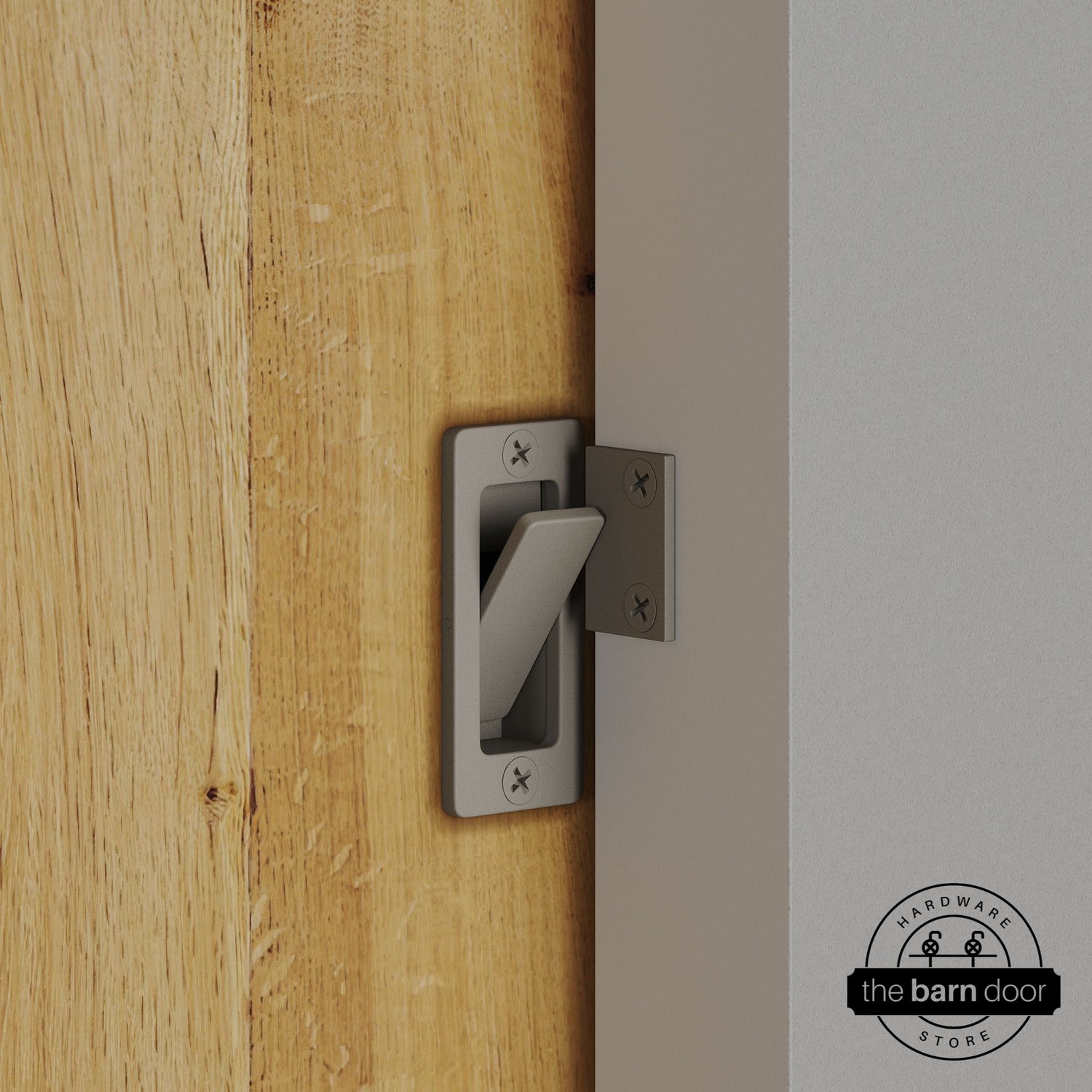 White bronze privacy latch installed on a sliding barn door, shown in the locked position against door frame