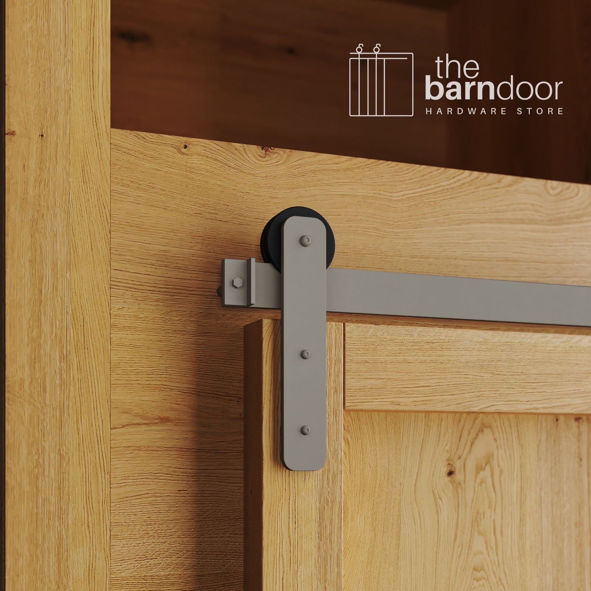 A close-up photograph of a natural oak cabinet with a sliding mini barn door, featuring a white bronze straight-strap hanger and a white bronze track system.