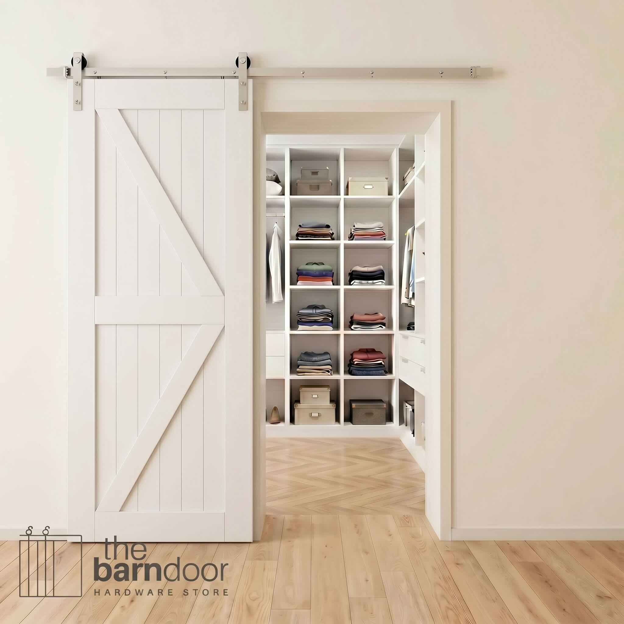 Brushed nickel barn door hardware kit on a white K-brace barn door, modern farmhouse style.